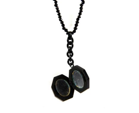 A jet portrait pendant and necklace.