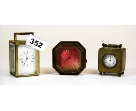 A miniature carriage clock, H. 8cm, and two alarm clocks.