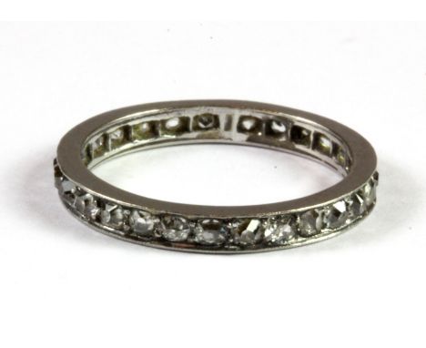 An early white metal (tested platinum) full eternity ring set with old cut cut diamonds, (N).