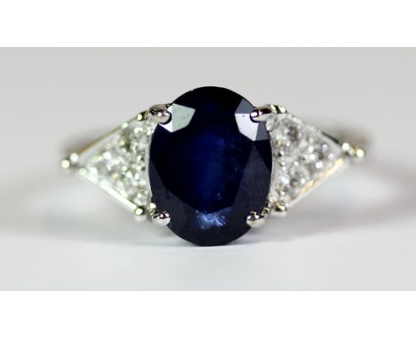 An 18ct white gold ring set with a 3ct sapphire with diamond set shoulders. Ring size M