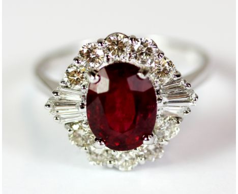 An 18ct white gold ring set with a treated ruby (approx 2.76ct) surrounded by diamonds (approx 0.87ct). Ring size M.5