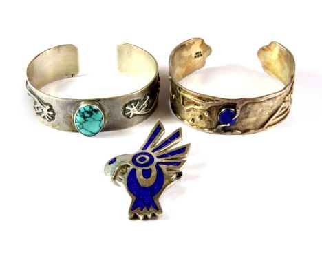 A Mexican 925 silver lapis lazuli set adjustable bangle, a further white metal (tested silver) turquoise set bangle and a 925