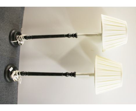 A pair of tall candlestick style table lamps and shades, L. 100cm.