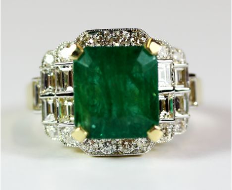 A lovely 18ct yellow gold ring set with an emerald (approx 3.48ct) surrounded by diamonds (approx 1.23ct). Ring size N