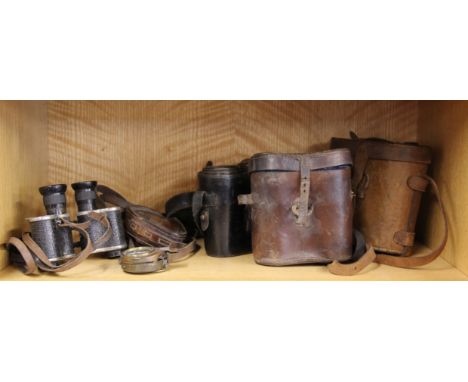 An early compass, a pair of field glasses dated 1915 and three further pairs of field glasses.