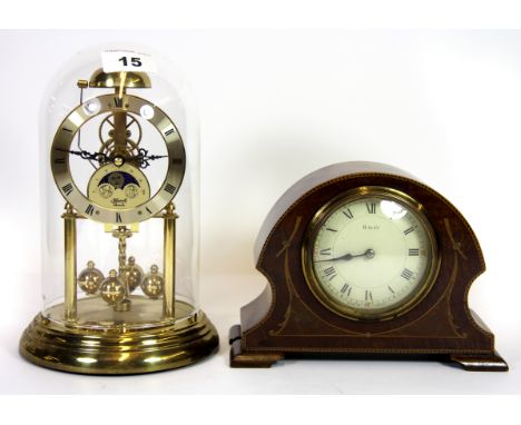 A moon phase anniversary clock and an inlaid mantle clock.