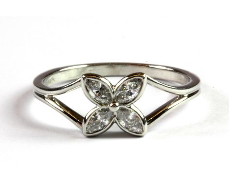 A Tiffany & Co platinum (stamped 950) flower shaped ring set with four marquise cut diamonds, (P.5), with Tiffany box and pur