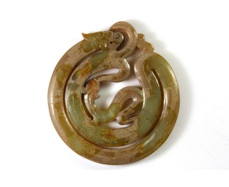 A Chinese carved archaic form jade amulet of the dragon with one of his sons, dia. 8cm.