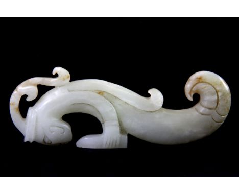 A carved Chinese mutton fat jade figure of a fish tailed deity, H. 13cm. Probably 19th century or earlier.