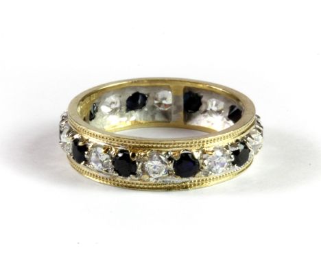 A 9ct yellow and white gold sapphire and cubic zirconia full eternity ring, (M).