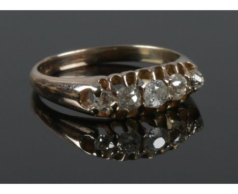 An early 20th century gold and five stone diamond ring. Tests as 9ct. Size O 1/2. 3.21g.  