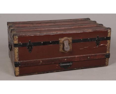A wood and brass bound twin handled trunk.  