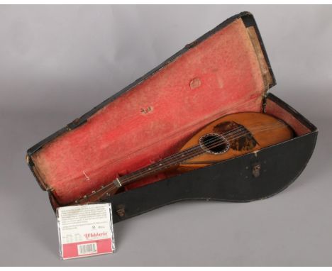 A vintage cased Italian mandolin bearing label for Domenico Banoni, instrument maker of Napoli. Bowl back with rosewood and t