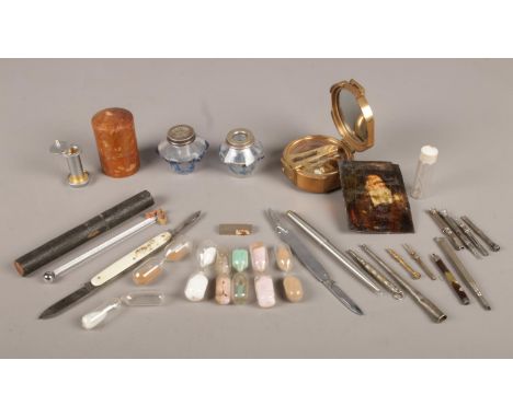 A small box of collectables. To include two glass ink wells, a brass compass, pen knifes and a small silver pencil etc.  