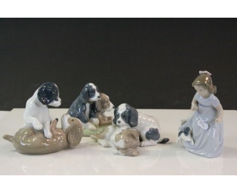 Four Nao ceramic figurines featuring Puppies