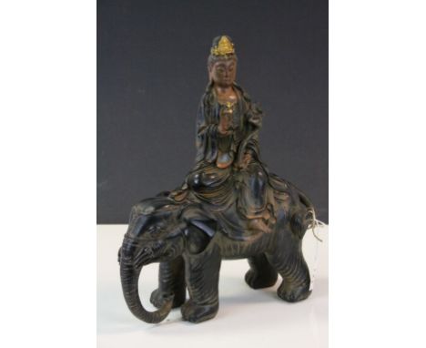 Vintage painted resin model of Guanyin seated on an Elephant, stands approx 35cm