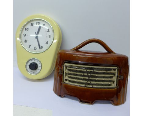 A modern kitchen clock and a ceramic heater