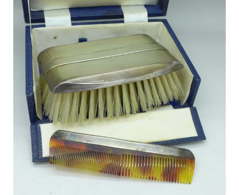 A cased silver backed brush and comb