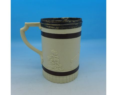 A silver rimmed mug, the base marked Turner, with raised hunting scene decoration, crazed