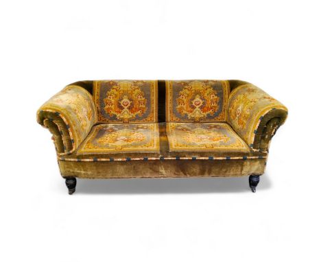 A late Victorian two-seater carpet sofa or loving seat, on ebonised turned legs, brass castors 160cm wide x 65cm high x 75cm 