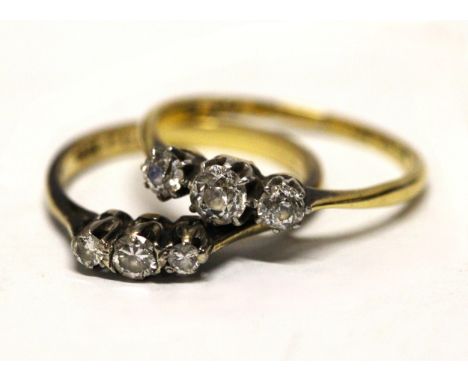 An 18ct gold and platinum diamond trilogy ring, the central old cut round diamond approx. 25pts flanked by two round old cut 