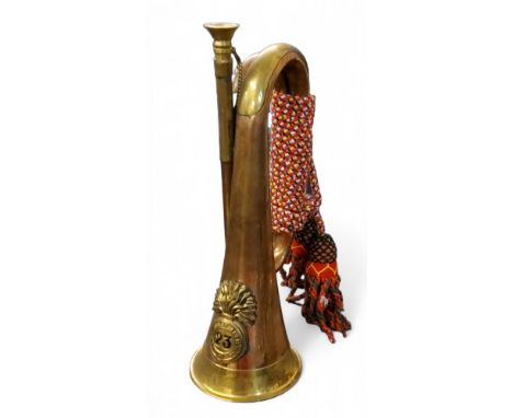 A copper and brass bugle,&nbsp; with applied badge for the 23rd Royal Welsh Fusiliers, 31cm long 