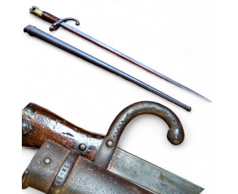 A 19th century French Gras bayonet, brass and mahogany grip, curved quillon, straight 52.5cm blade, etched Mre D’Armes de St 