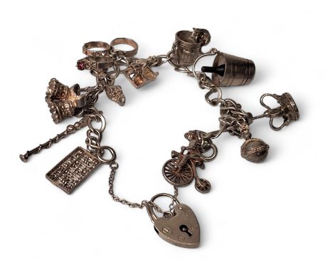 A silver charm bracelet, twelve pendants including dustbin &amp; cat, sceptre, crown, abacus etc., 36.47g 