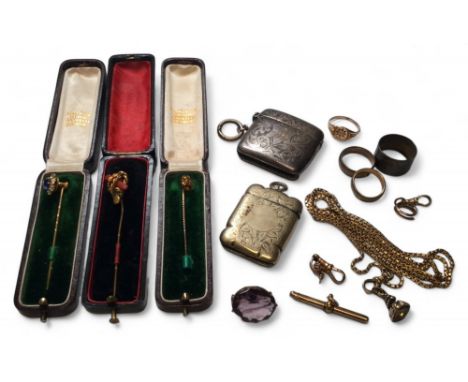A Victorian stick pin, the floral setting stamped 15ct gold, set with a diamond chip 0.96g gross; a yellow metal floral stick