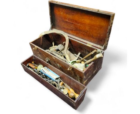A 19th century tool chest, with contents including scythes, chisels, vintage tins and other tools 