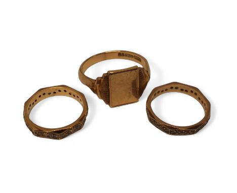 A 9ct gold signet ring, size V1/2, 5.35g; a pair of 9ct gold full eternity octagonal rings, centrally set with round white st