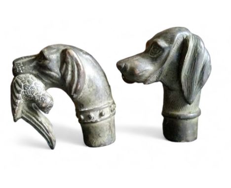 A novelty bronze walking stick handle, as a gun dog, with game, 7cm high;&nbsp; another, 7cm high (2) 
