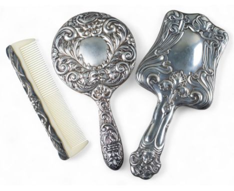 Two silver hand mirrors and a silver metal comb [a] Art Nouveau, decorated with repoussé floral design, hallmarked Birmingham