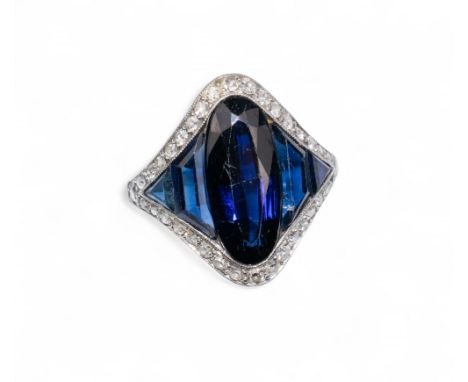 An Art Deco diamond and synthetic sapphire dress ring The fine platinum setting set with a large oval sapphire and calibre cu