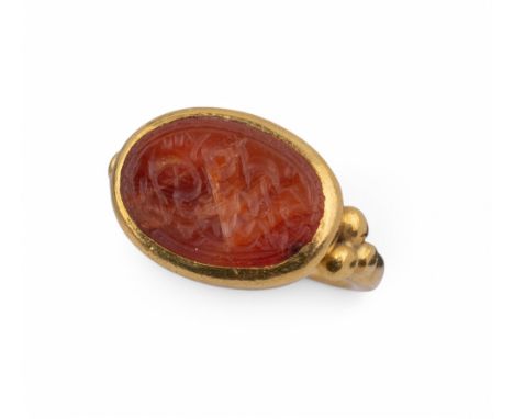 Indian An antique yellow gold ring with Quranic intaglio engraved carnelian inset to the top Ring size: J Total weight: Appro