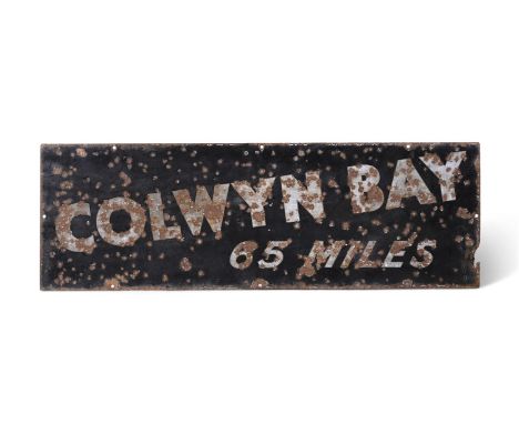 AN ENAMEL ROAD SIGN 'COLWYN BAY 65 MILES'  PROBABLY FIRST HALF 20TH CENTURY  30.5cm high, 91.5cm wide   