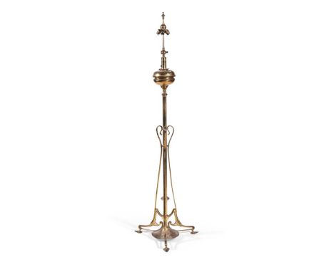 A GILT BRASS STANDARD LAMP  LATE 19TH CENTURY  With turned oil reservoir above scrolling supports and base, rewired and PAT t