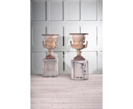 A PAIR OF CAST IRON URNS OF CAMPANA FORM  ATTRIBUTED TO THE HANDYSIDE FOUNDRY, DERBY, CIRCA 1860-1880   Now raised on carved 