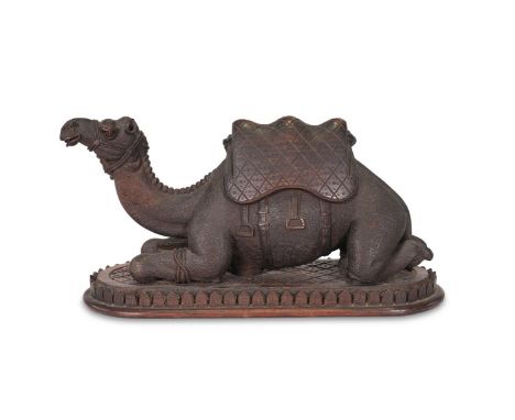 Y&nbspA CARVED EXOTIC HARDWOOD MODEL OF A RECUMBENT CAMEL   LATE 19TH CENTURY  16cm high, 11cm wide, 27cm long overall   A cl