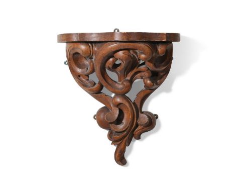 A LARGE CARVED AND GRAINED WALL BRACKET 19TH CENTURY Of architectural form 53cm high, 48cm wide, 31cm protuberance  Condition