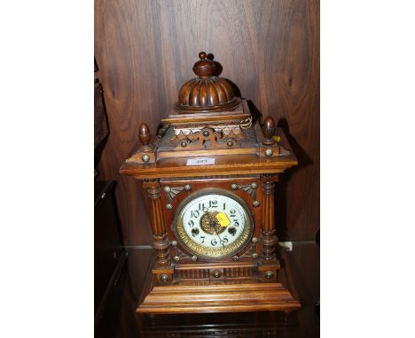 A COLONIAL STYLE MANTLE CLOCK