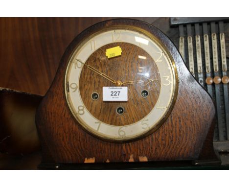 AN OAK MANTEL CLOCK