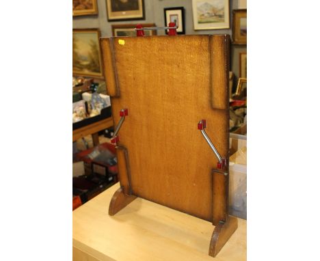AN ART DECO FIRESCREEN WITH RED BAKELITE