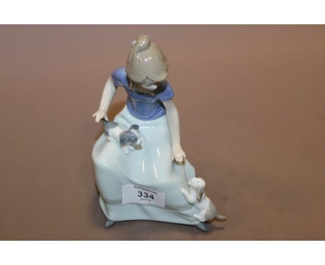 A NAO FIGURE OF A SEATED LADY WITH PUPPIES