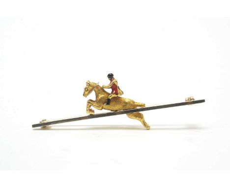 A yellow metal and enamel hunting bar brooch, the yellow metal horse with jockey up, enamelled coat, cap and boots, the white