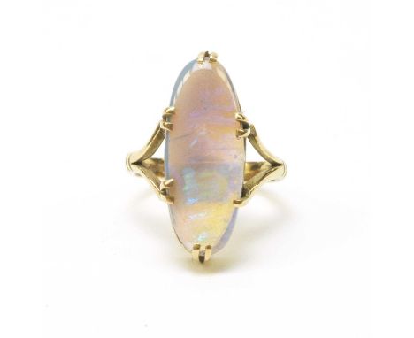 An opal ring, the oval opal cabochon measuring approximately 23.0 x 9.1 x 4.0mm, claw set in a textured 9ct. yellow gold moun