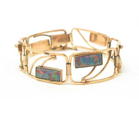 An opal and yellow metal bracelet, the graduated open plaque links each set with an opal doublet, in millegrain collet settin