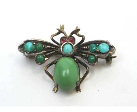 An early 20th Century fly pattern brooch, the body set with turquoise cabochons, ruby set eyes, in white and yellow metal mou