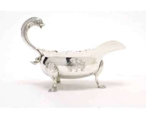 A George III silver sauceboat, by Robert Makepeace I, Newcastle 1754, the body with cut shaped rim, fitted stylized dolphin h