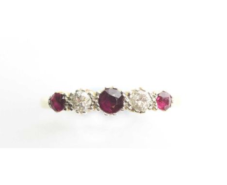 A ruby and diamond ring, the three graduated circular facet cut rubies parted by two old-cut diamonds weighing a total of app